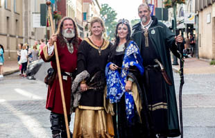 four people pose for a photo during the 2016 Queen city mischief and magic