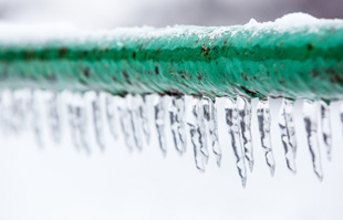 a frozen pipe with icicles