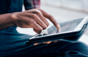 Hand touching a tablet
